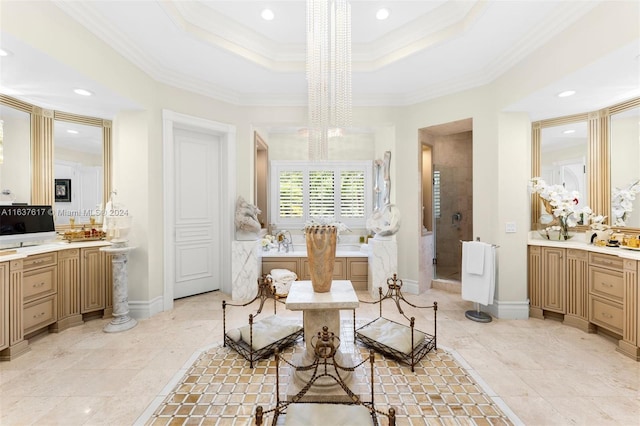 interior space with a raised ceiling, an inviting chandelier, and ornamental molding