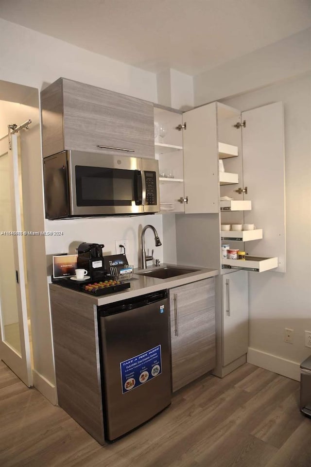 bedroom featuring sink and dark hardwood / wood-style floors