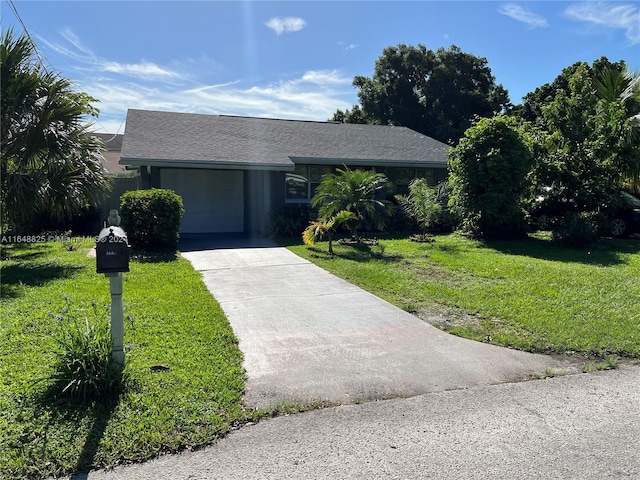 single story home featuring a garage and a front lawn