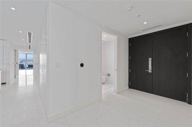 bedroom featuring a wall of windows and ensuite bathroom