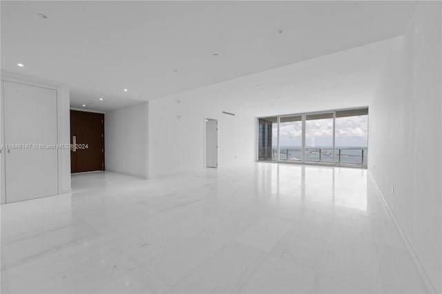 tiled spare room with expansive windows