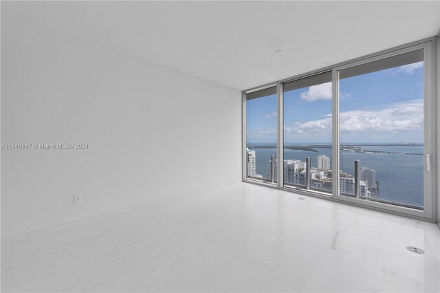 300 Biscayne Blvd Way Unit 4604, Miami, FL 33131 - empty room featuring expansive windows, a water view, and tile patterned flooring