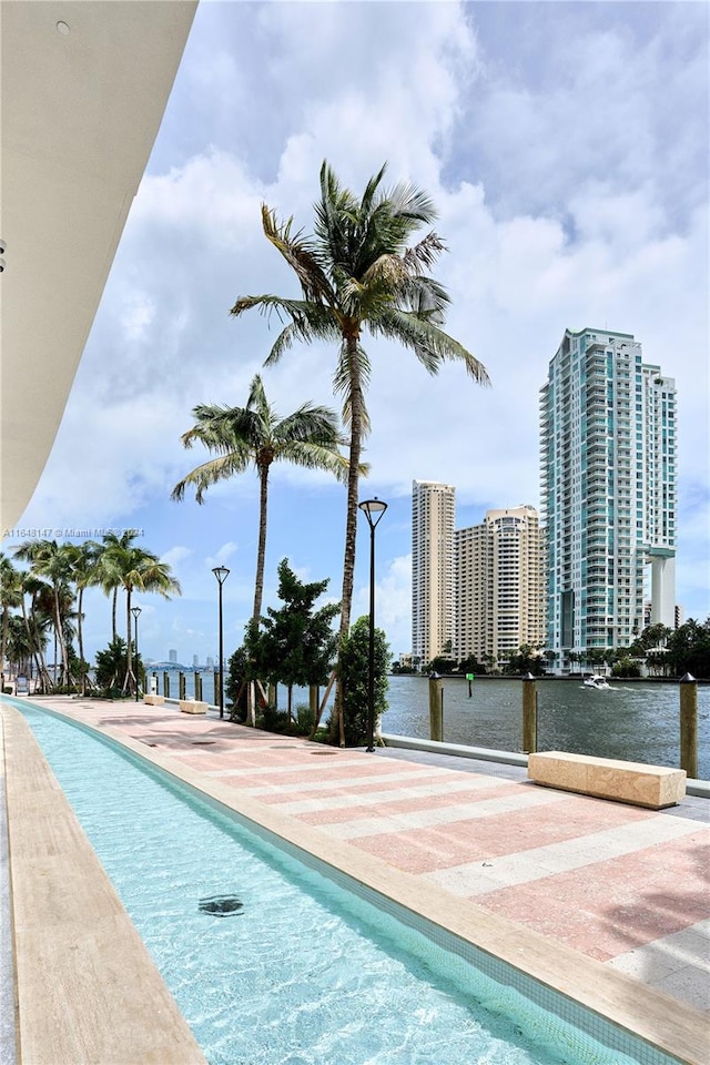 view of swimming pool with a water view