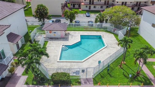 view of pool with a patio area and a yard