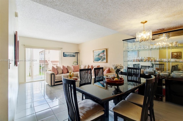 dining room with a notable chandelier, a textured ceiling, and light tile patterned floors