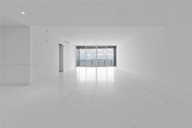 unfurnished room featuring floor to ceiling windows