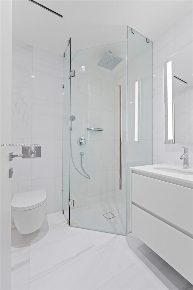 bathroom featuring vanity, a shower with shower door, toilet, and tile walls