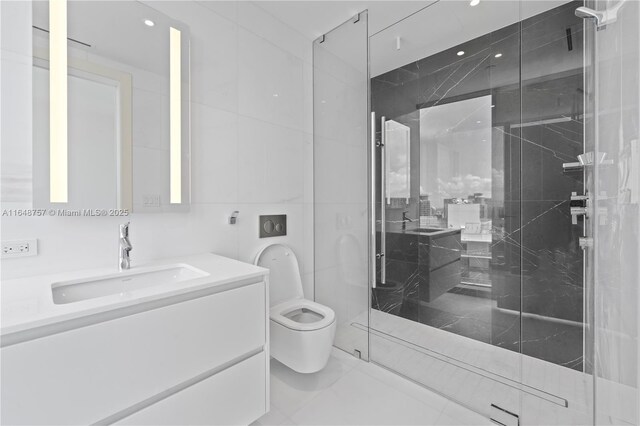 bathroom with vanity, an enclosed shower, tile walls, and toilet