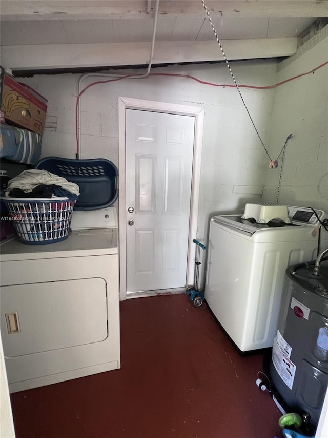 clothes washing area with washer and clothes dryer and water heater