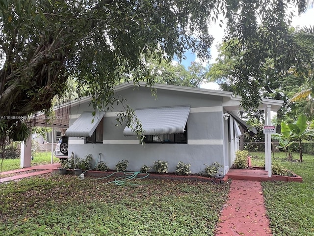 940 NW 34th Ave, Lauderhill, FL 33311 - view of side of home with stucco siding, fence, and a cooling unit
