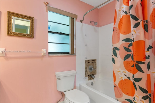 bathroom with shower / bath combo and toilet