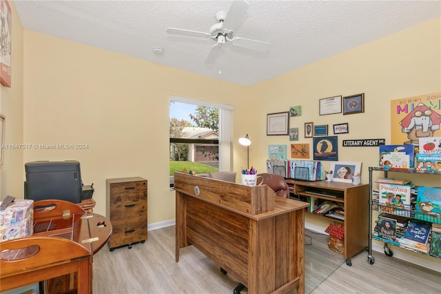 office space with ceiling fan, a textured ceiling, and light hardwood / wood-style flooring