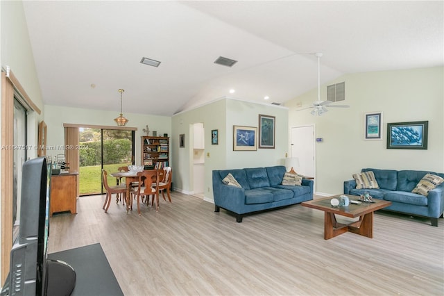 living room featuring ceiling fan, vaulted ceiling, and light wood-type flooring