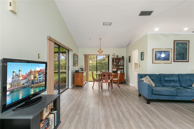 living room with light wood-type flooring and high vaulted ceiling