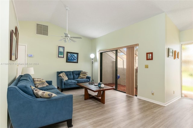 living room featuring ceiling fan, vaulted ceiling, and wood-type flooring