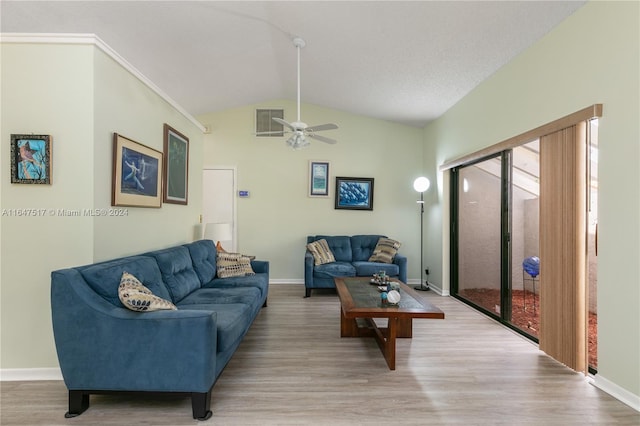 living room featuring ceiling fan, vaulted ceiling, and hardwood / wood-style flooring