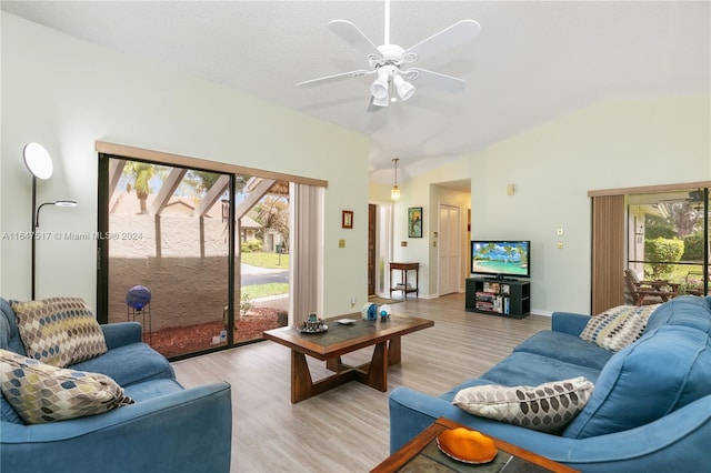 living room with ceiling fan, light wood-type flooring, and lofted ceiling