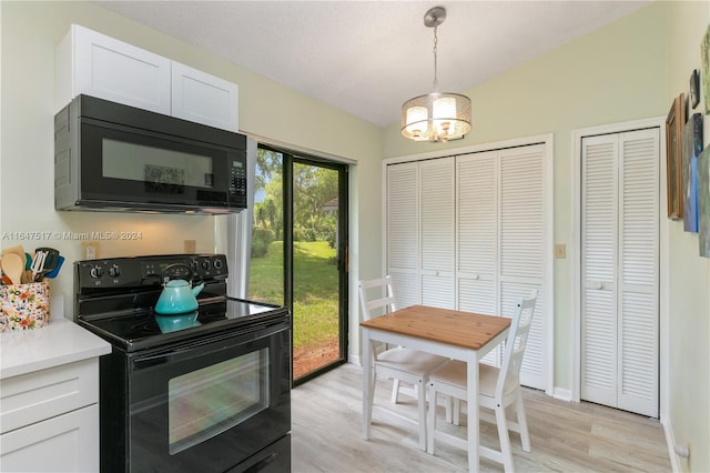 kitchen with white cabinetry, an inviting chandelier, black appliances, and light wood-type flooring