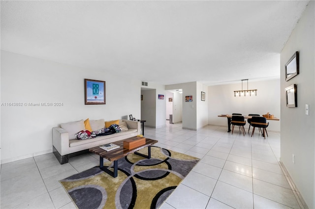 living room featuring a notable chandelier and light tile patterned flooring