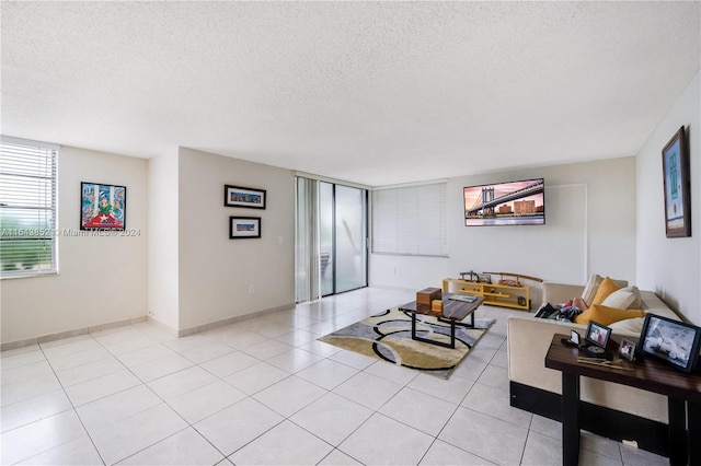 tiled living room featuring a textured ceiling