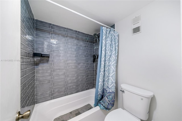 bathroom with shower / tub combo with curtain and toilet