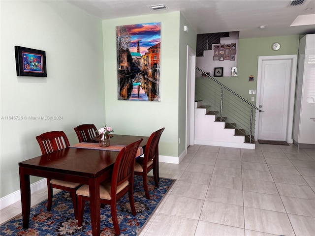 dining space featuring light tile patterned flooring