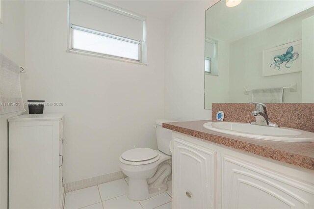 bathroom featuring toilet, vanity, and tile patterned floors