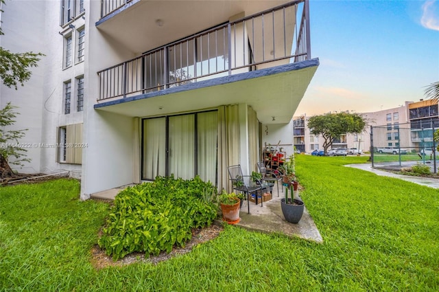 exterior space featuring a yard and a balcony