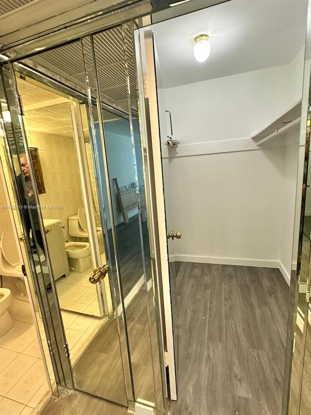 walk in closet featuring tile patterned flooring and washer / clothes dryer