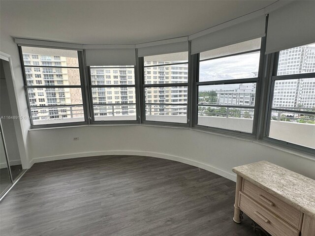 unfurnished bedroom with dark hardwood / wood-style floors