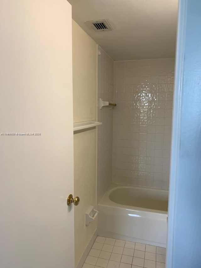 full bath featuring tile patterned flooring and tub / shower combination