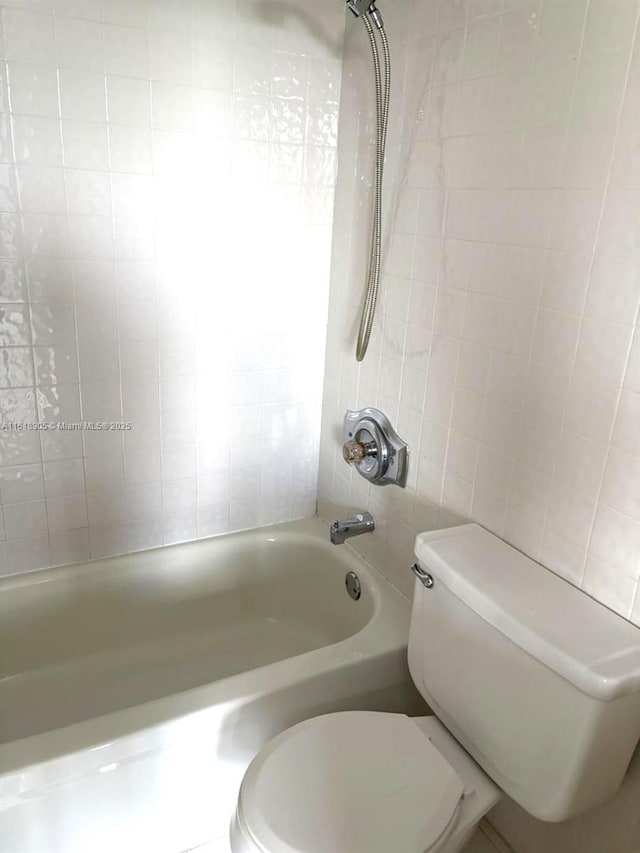 full bathroom featuring toilet, shower / washtub combination, and tile walls