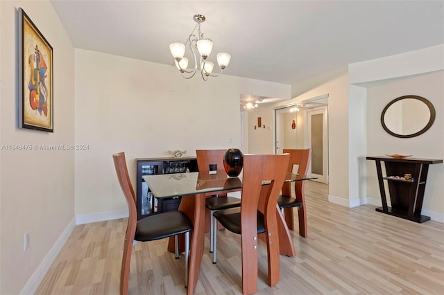 dining room featuring a chandelier and light hardwood / wood-style flooring