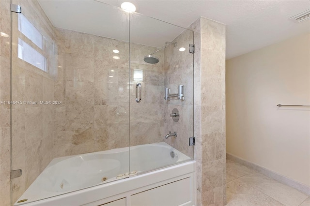 bathroom featuring tile patterned flooring and enclosed tub / shower combo