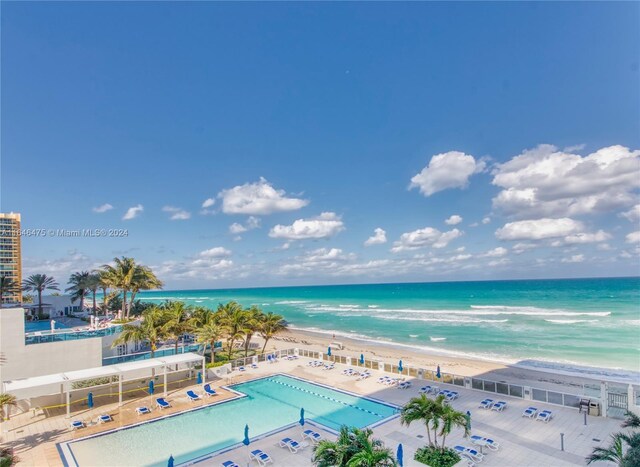 aerial view with a water view and a beach view