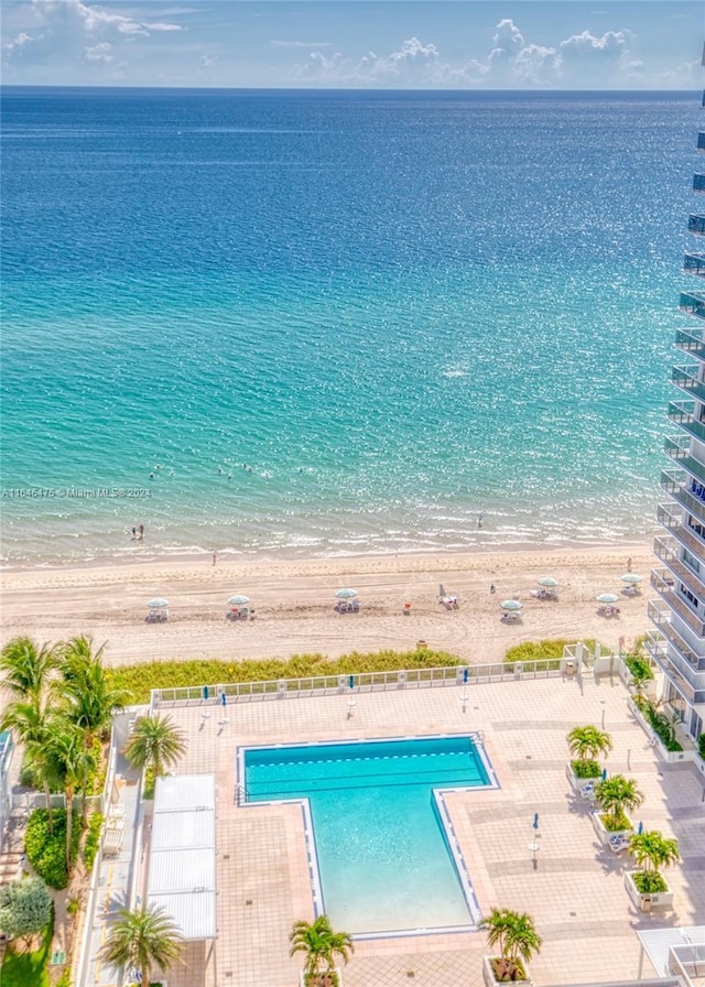 aerial view with a water view and a beach view