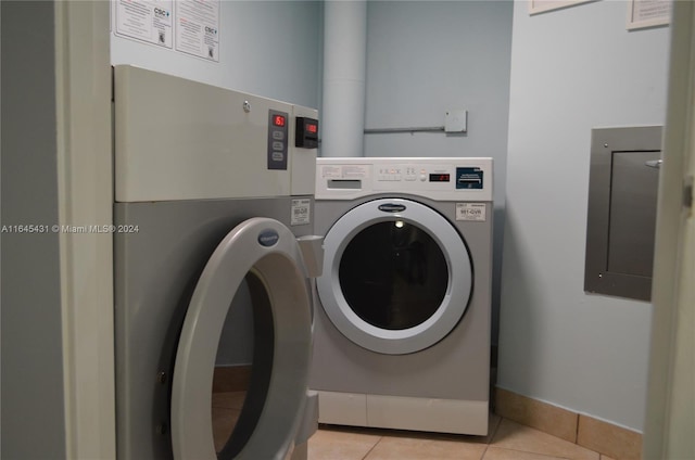 clothes washing area featuring light tile patterned floors