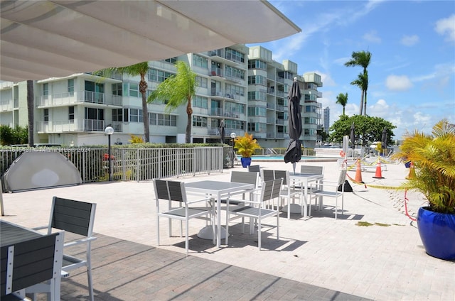 view of patio / terrace featuring a community pool and a balcony