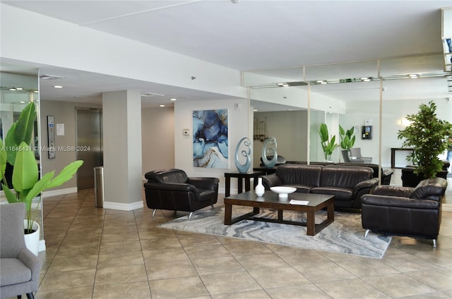 living room with elevator and light tile patterned floors