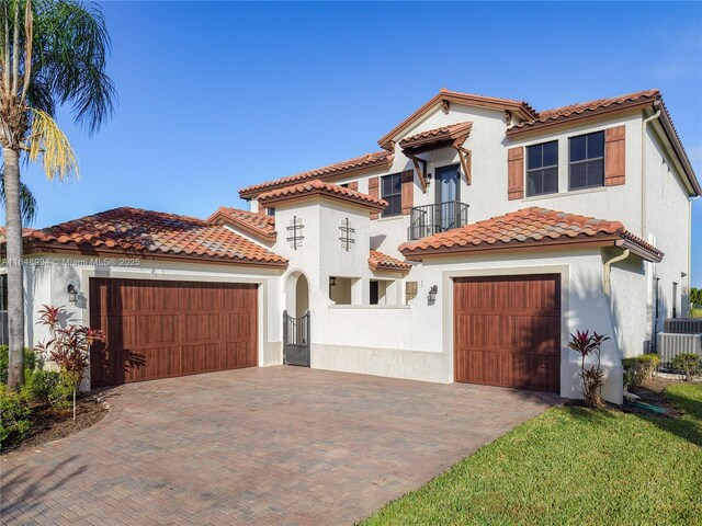 mediterranean / spanish-style house with a garage