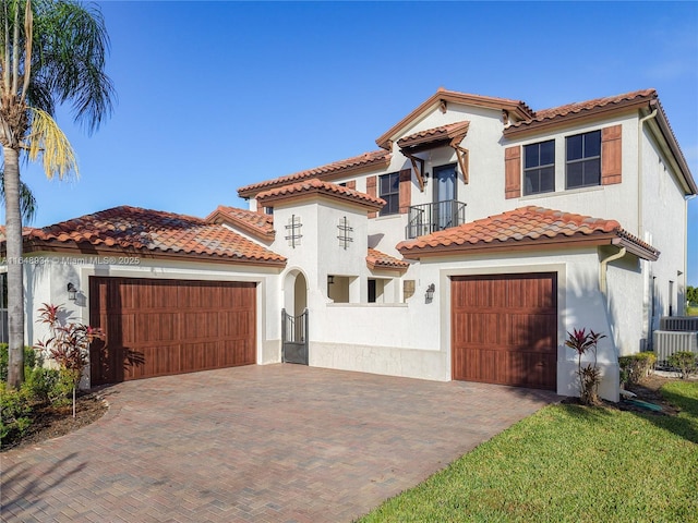 mediterranean / spanish-style house with a garage