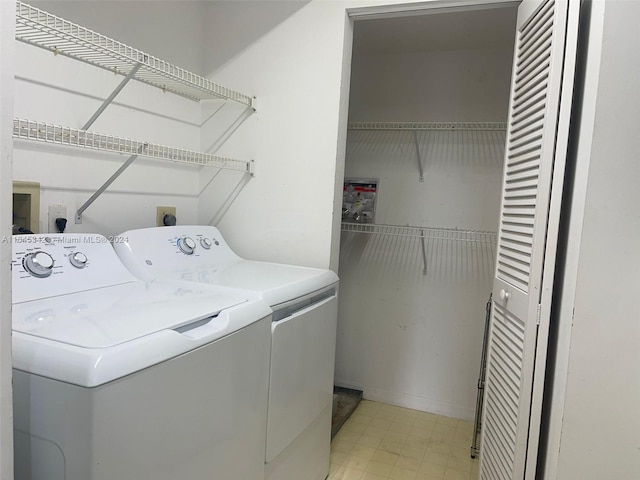 washroom with light tile patterned flooring and separate washer and dryer