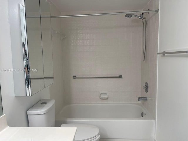 full bathroom featuring vanity, toilet, and tiled shower / bath