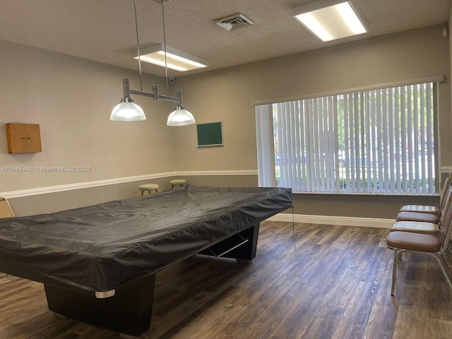 recreation room featuring billiards, a wealth of natural light, dark hardwood / wood-style floors, and a textured ceiling