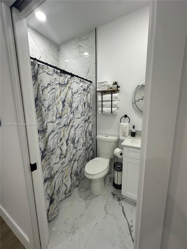 bathroom featuring a shower with curtain, toilet, and vanity