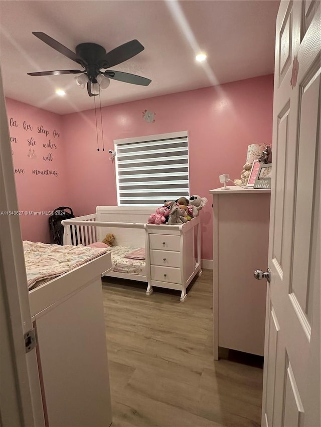 bedroom with wood-type flooring and ceiling fan