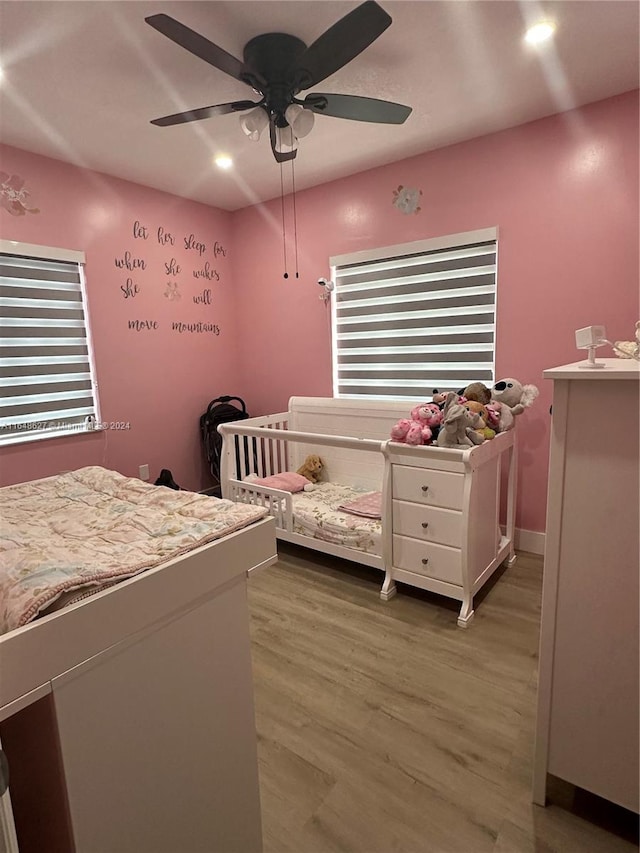 bedroom with wood-type flooring and ceiling fan