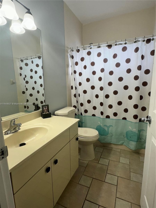 bathroom with vanity, toilet, and curtained shower