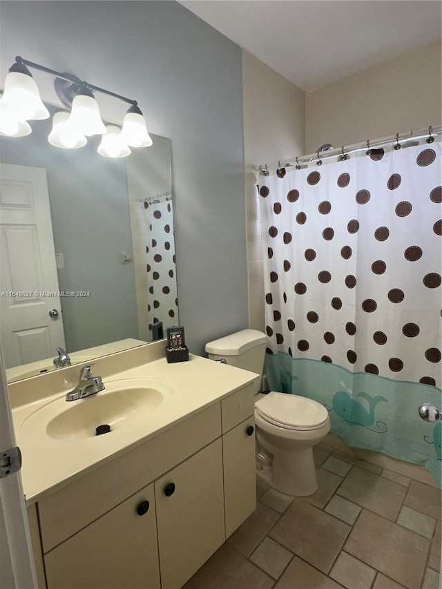 bathroom featuring vanity, toilet, and walk in shower