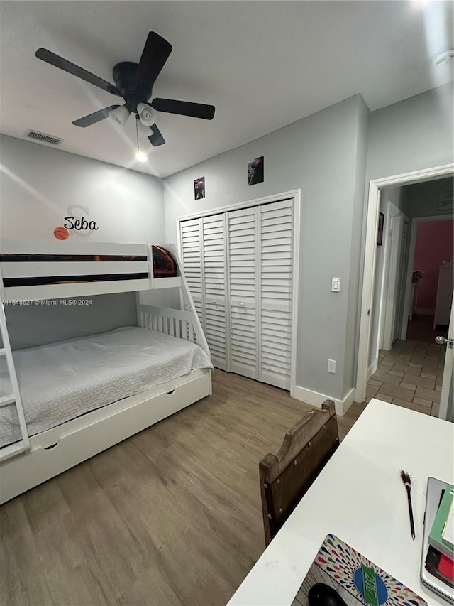 bedroom with a closet, ceiling fan, and hardwood / wood-style flooring